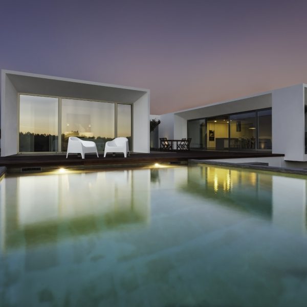 Modern house with garden swimming pool and wooden deck